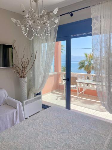 a bedroom with a bed and a view of the ocean at Ostraco Suite 1 in Nafpaktos