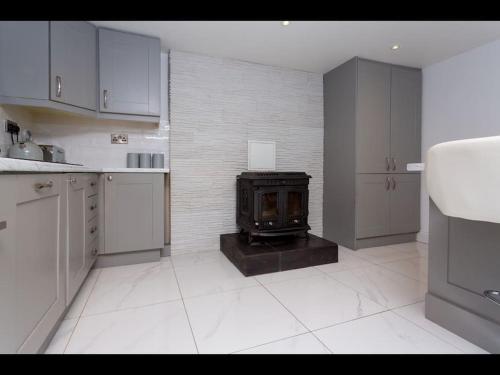 a kitchen with a stove in the middle of it at Churchview in Cahersiveen