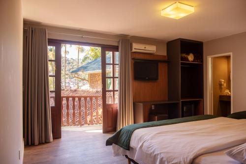 Ένα ή περισσότερα κρεβάτια σε δωμάτιο στο Hotel Vila Verde