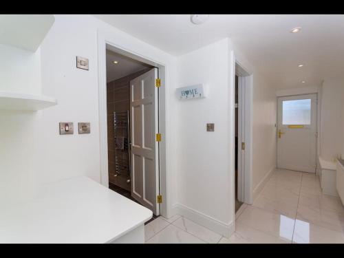 a white room with an open door and a bathroom at Churchview in Cahersiveen