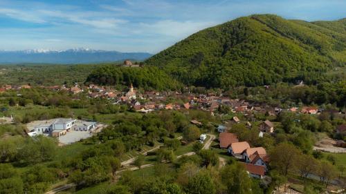 an aerial view of a small town in the mountains at Glamping Cisnadioara in Cisnădioara