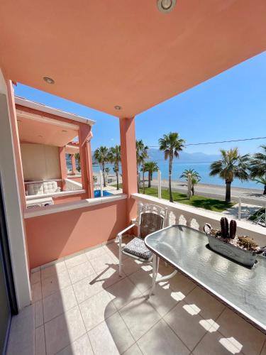 a balcony with a table and a view of the ocean at Ostraco Suite 1 in Nafpaktos