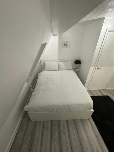 a bedroom with a white bed in a attic at Nice & Cozy Furnished 1 Bedroom Flat in Luton