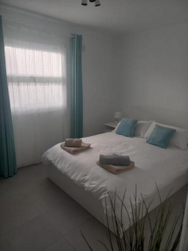 a bedroom with a large bed with towels on it at Club Del Mar No.8 in Puerto del Carmen