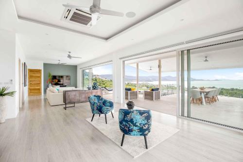 a living room with a couch and chairs at Sunset Estates - Samui Luxury Villas in Choeng Mon Beach