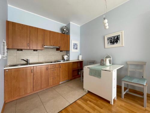 a kitchen with wooden cabinets and a sink at Apartment Platinum in Międzyzdroje