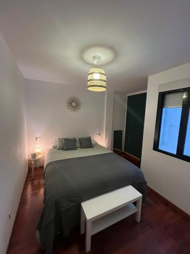 a bedroom with a large bed and a window at Los Bell@s in O Porto de Espasante
