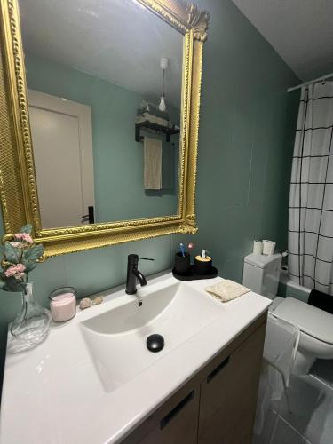 a bathroom with a white sink and a mirror at Los Bell@s in O Porto de Espasante