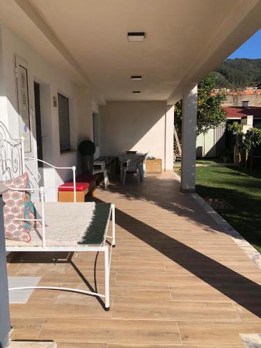 a porch with a white bench on a house at Casa da Avó Olinda in Góis