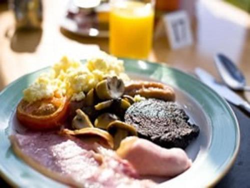 a plate of breakfast food on a table at Old Manor Hotel in Lundin Links