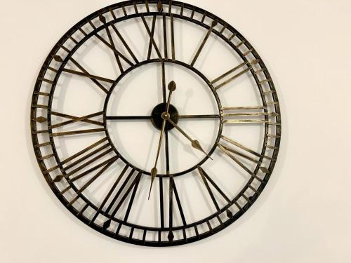 a large black and white clock on a wall at Captivating 2-Bed Apartment in Maidstone in Maidstone