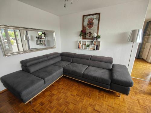 a living room with a black leather couch at 2 bedroom Apartment at Bahnhofcity in Feldkirch