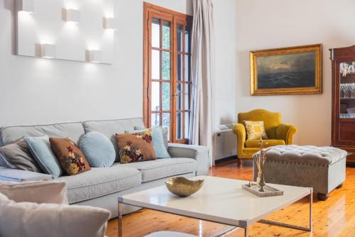 a living room with a couch and a table at MyThea Villa by "elite" in Lithakia