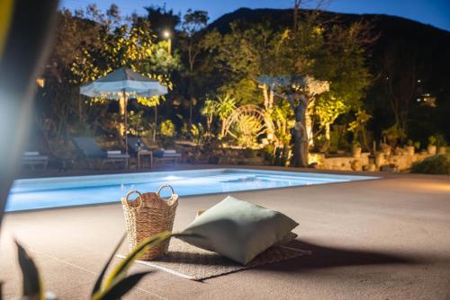 a pair of baskets sitting next to a swimming pool at MyThea Villa by "elite" in Lithakia