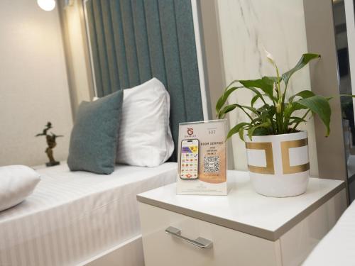 a room with a bed with a plant on a table at gazelle suites in Istanbul
