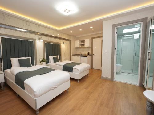 a hotel room with two beds and a bathroom at gazelle suites in Istanbul