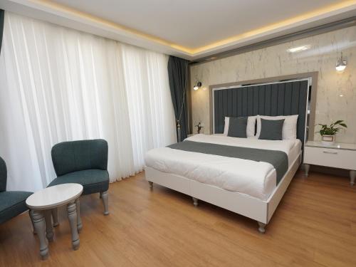 a hotel room with a bed and a chair at gazelle suites in Istanbul