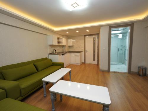 a living room with a green couch and a table at gazelle suites in Istanbul
