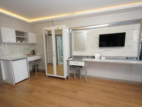 a room with a desk and a tv on a wall at gazelle suites in Istanbul