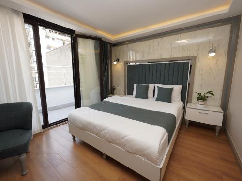 a bedroom with a large bed and a chair at gazelle suites in Istanbul