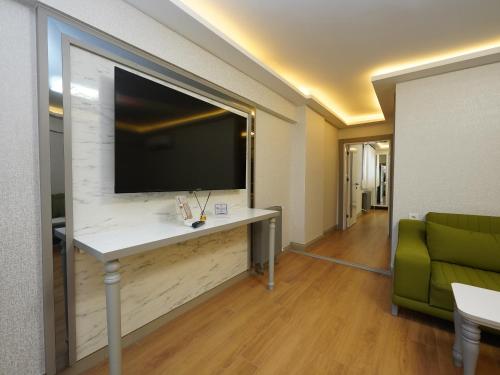 a living room with a large tv on a wall at gazelle suites in Istanbul