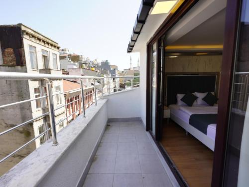 a balcony with a bed on top of a building at gazelle suites in Istanbul