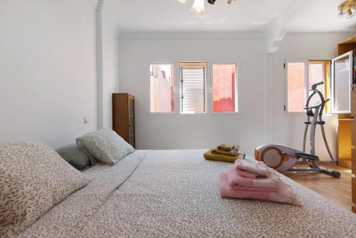 a bedroom with a bed with a pink blanket on it at Casa La Herradura in Telde