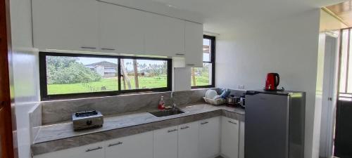 a kitchen with a sink and a window at Casa Victoria Pension House-Star Maria in Somosomo