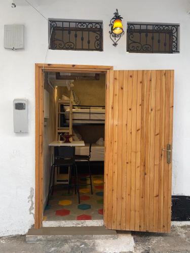 drewniane drzwi prowadzące do pokoju ze stołem w obiekcie Le Studio 46 w mieście Tanger