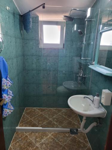 a bathroom with a sink and a shower at Studios Kalina in Budva