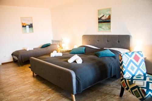 a bedroom with a large bed and a couch at Sun Valley Apartments in Maishofen