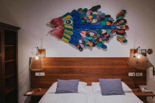 a bedroom with a bed with a colorful head board at Boutiquehotel Stadthalle in Vienna