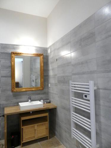 a bathroom with a sink and a mirror at Domaine de la Vidalle in Vendres