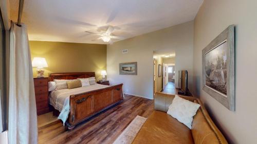 a bedroom with a bed and a couch at Escape to Magnolia Run 2 Bedroom Golf Villa in Pawleys Island