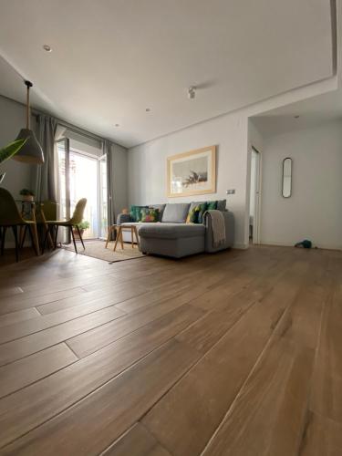 a living room with a couch and a wooden floor at Charito 18 in Cádiz