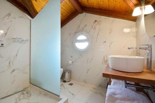 a bathroom with a sink and a mirror at Hotel Orpheus in Gouvia