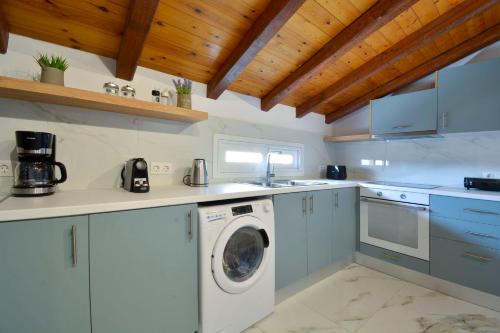 a kitchen with a washer and a washing machine at Hotel Orpheus in Gouvia