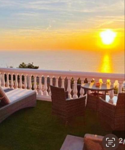 a balcony with a table and chairs and the ocean at B&B La Danza del Mare in Anacapri
