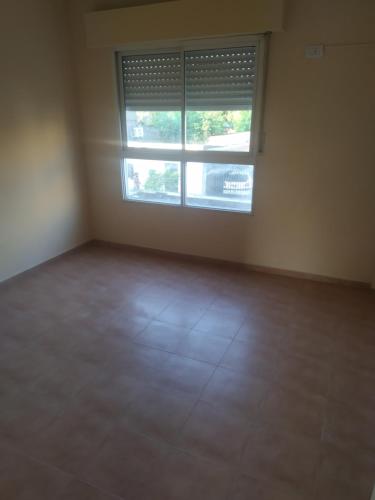 an empty room with a window and a tiled floor at Dpto 1 dorm Parque Avalos in Resistencia