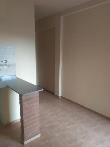 a room with a brick counter and a door at Dpto 1 dorm Parque Avalos in Resistencia