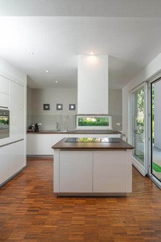 a kitchen with white cabinets and a large island at Luxury Apartment Nana in Bled
