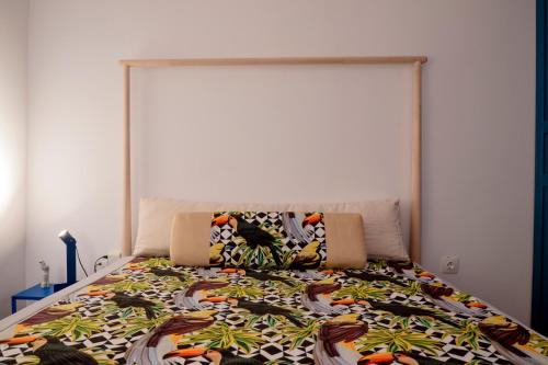 a bedroom with a bed with a large headboard at Parrot Palazzo in Nea Kallikrateia