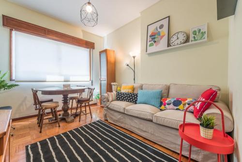 a living room with a couch and a table at GuestReady - Sweet & Relax Flat in Porto