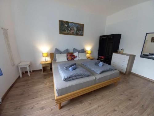 a bedroom with a bed with two pillows on it at Vidám ház, a Zöld Szívü faluban Sopron mellett in Sopronkövesd