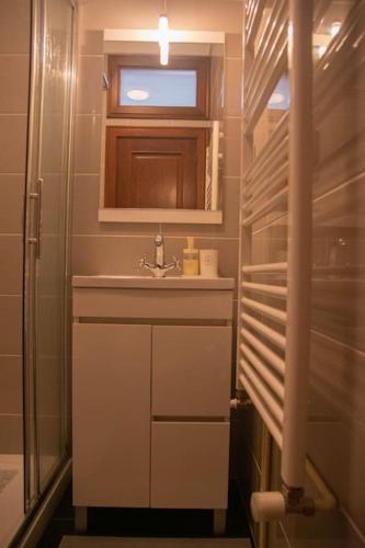 a small bathroom with a sink and a window at Cosy Historical House in Lamego - Quinta do Cabo in Lamego