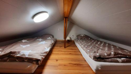 a bedroom with a bed in a attic at Chalet Idylka in Saignelégier