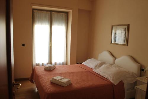 a bedroom with a bed with two towels on it at Casa Paolina in Lucca