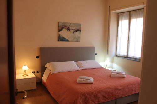 a bedroom with a bed with two towels on it at Casa Paolina in Lucca