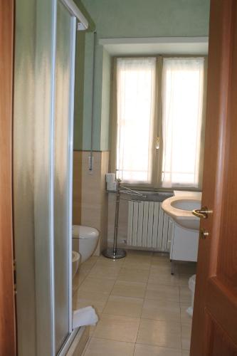 a bathroom with a tub and a toilet and a sink at Casa Paolina in Lucca