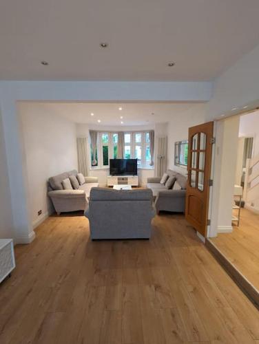a large living room with couches and a television at Large 6 Bedroom house in Hendon in Hendon